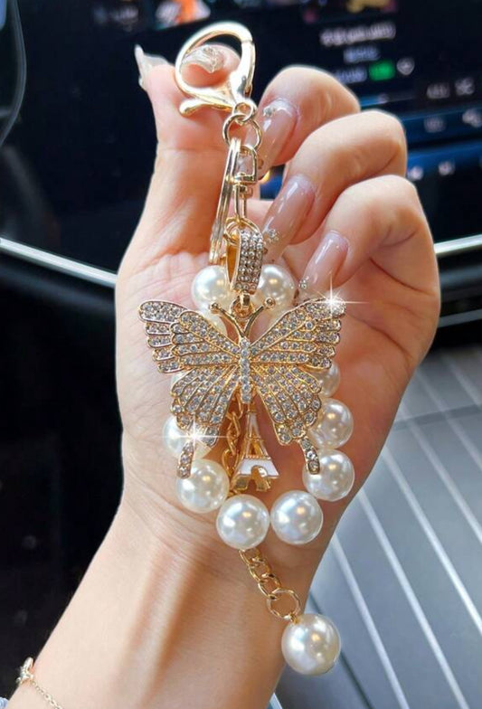 Gold butterfly. Pearl bracelet and keychain