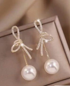 Long pearl and bow earrings