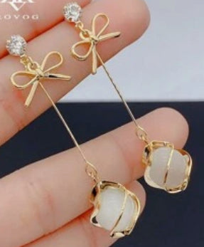 Long dangling earrings with bow